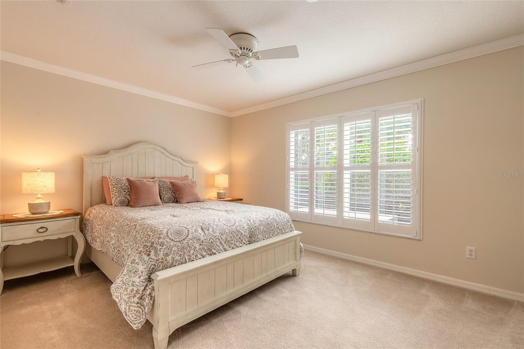 10915 Ledgement Lane Windermere, FL 34786 - Photo 30 of 60 a bed room with a bed and a ceiling fan