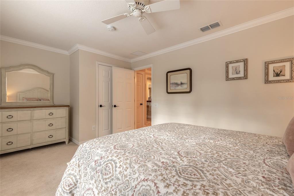 10915 Ledgement Lane Windermere, FL 34786 - Photo 31 of 60 a bedroom with a bed and a dresser