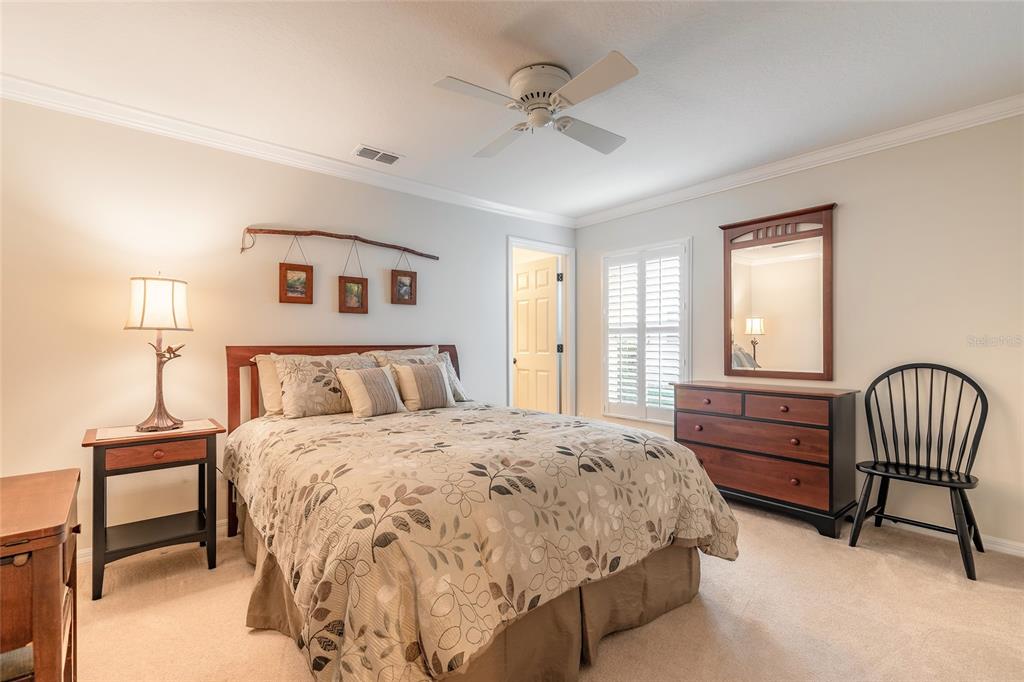 10915 Ledgement Lane Windermere, FL 34786 - Photo 36 of 60 a bedroom with a bed chairs and a window