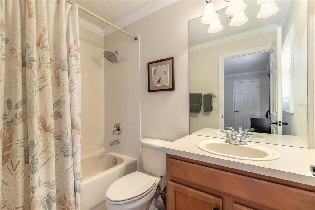 10915 Ledgement Lane Windermere, FL 34786 - Photo 38 of 60 a bathroom with a granite countertop sink mirror toilet and bathtub