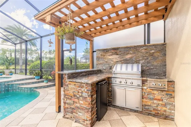an aerial view of a house with a garden and lake view