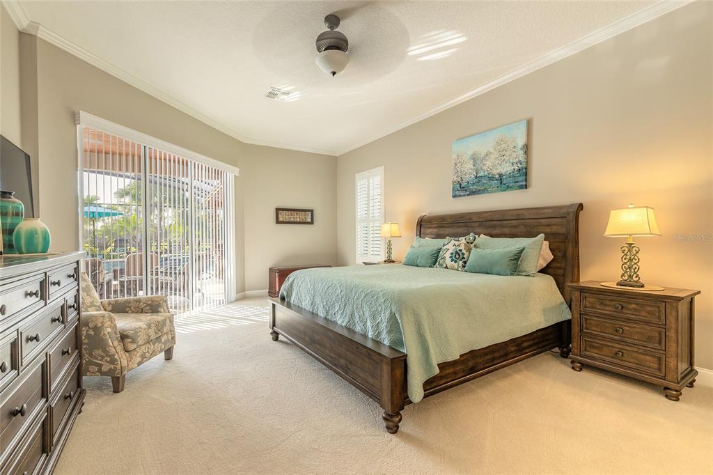 10915 Ledgement Lane Windermere, FL 34786 - Photo 5 of 60 a spacious bedroom with a bed a couch and large window