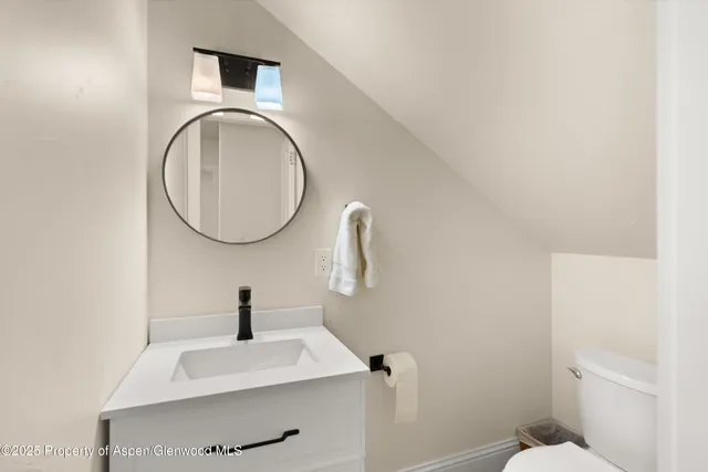 a bedroom with a bed and a chair