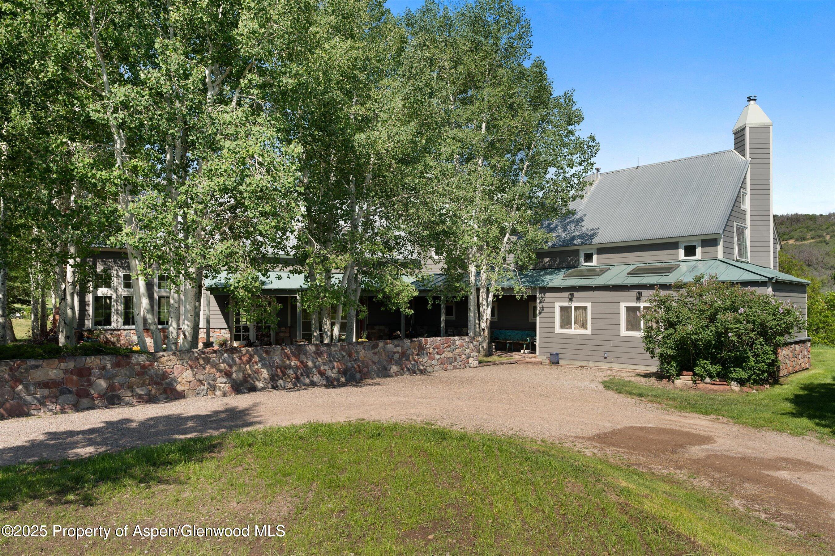 2240 Old Herron Road Basalt, CO 81621 - Photo 2 of 42 a front view of a house with a yard and trees