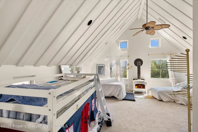 a kitchen with stainless steel appliances granite countertop a stove a refrigerator a oven a white table and chairs