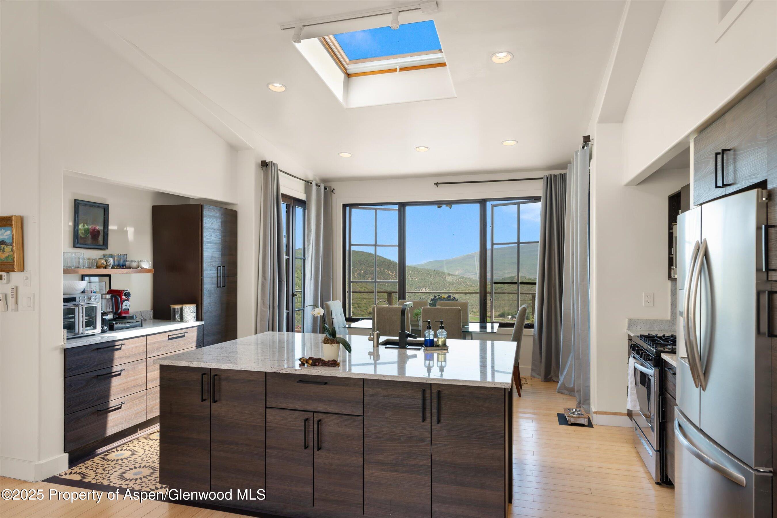 2240 Old Herron Road Basalt, CO 81621 - Photo 29 of 42 a kitchen with stainless steel appliances granite countertop a refrigerator and a sink