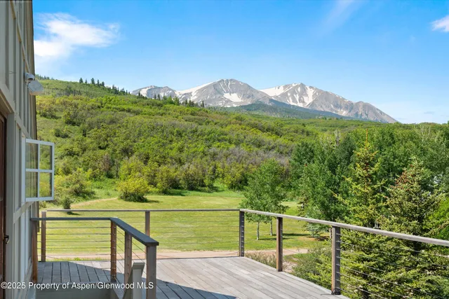 a view of a lush green hillside and a houses