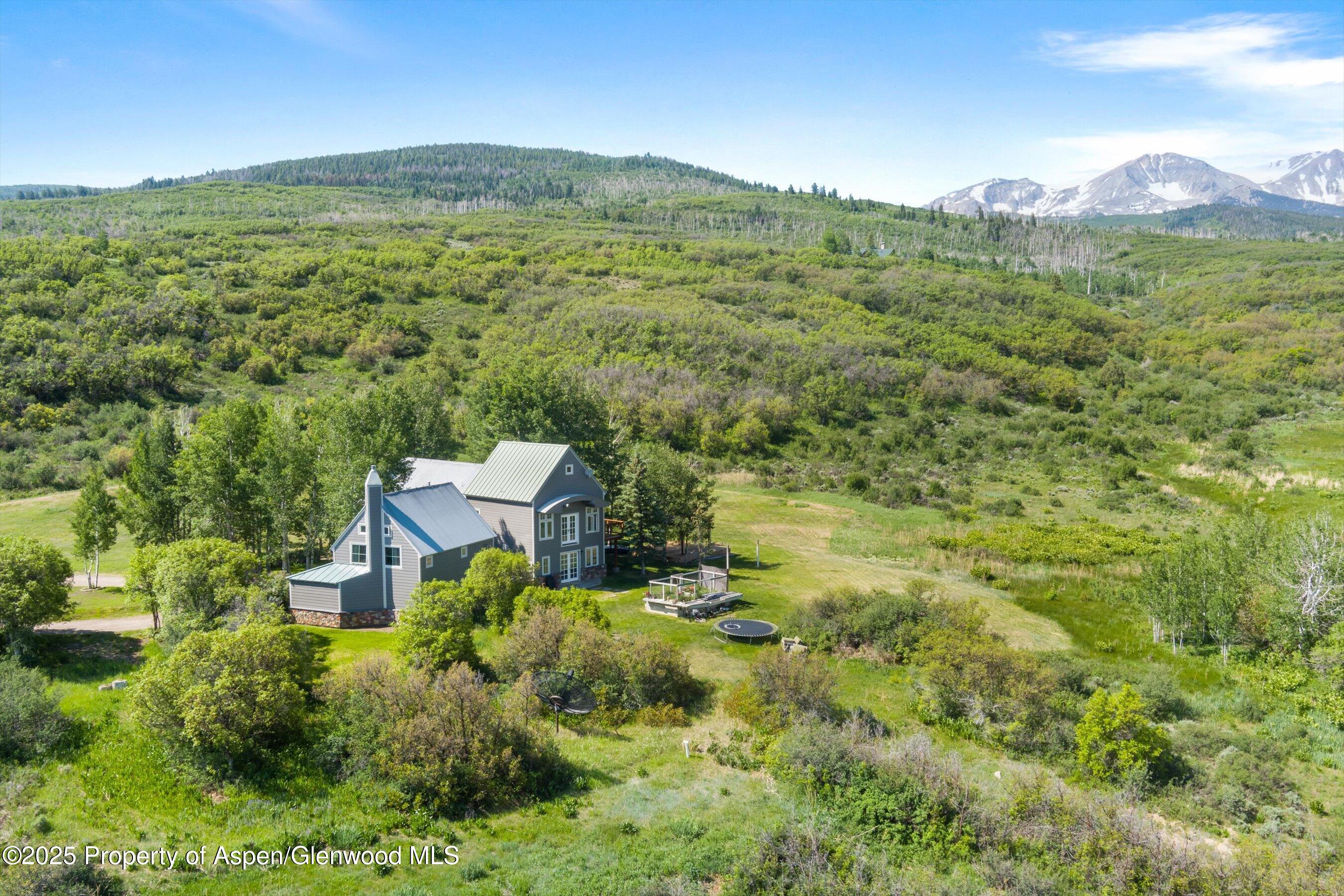 2240 Old Herron Road Basalt, CO 81621 - Photo 38 of 42 a view of a lush green hillside and a houses