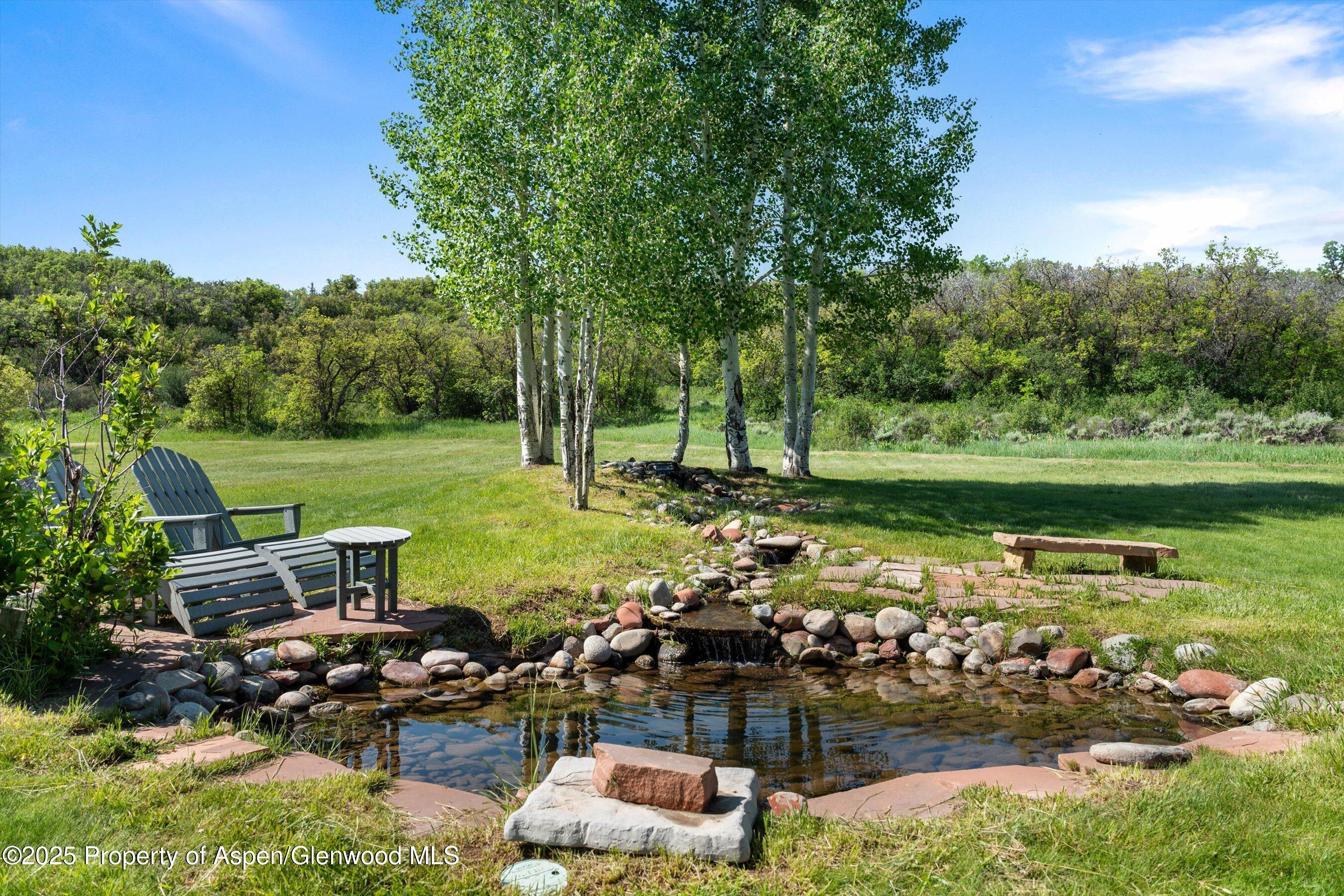 2240 Old Herron Road Basalt, CO 81621 - Photo 40 of 42 a view of a lake with a lawn chairs and a fire pit