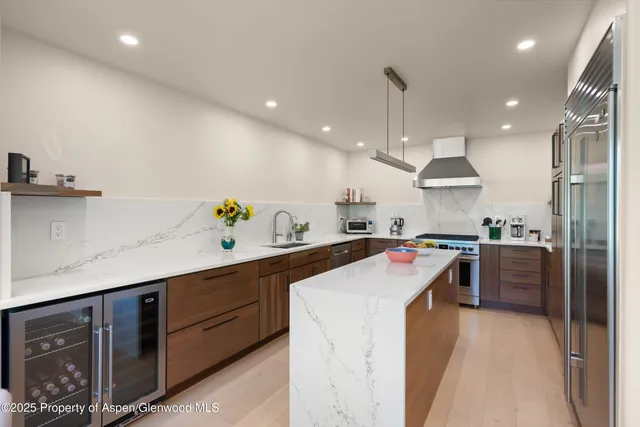 a kitchen with a dining table and chairs