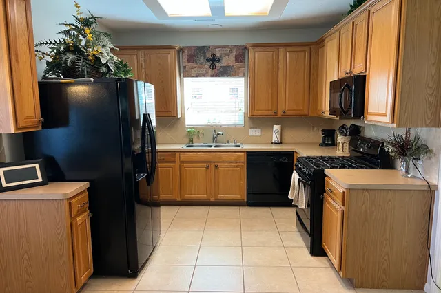 a kitchen with a sink a stove and a refrigerator