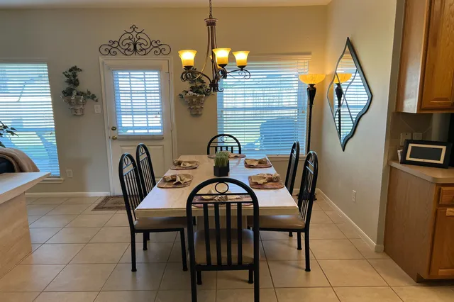 a view of a dining room with furniture and window