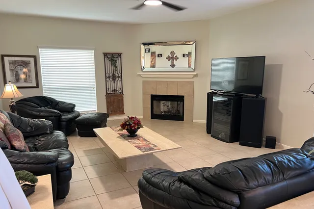 a living room with furniture and a fireplace