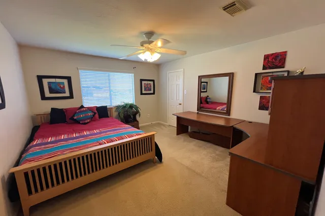 a bedroom with a bed and a chandelier