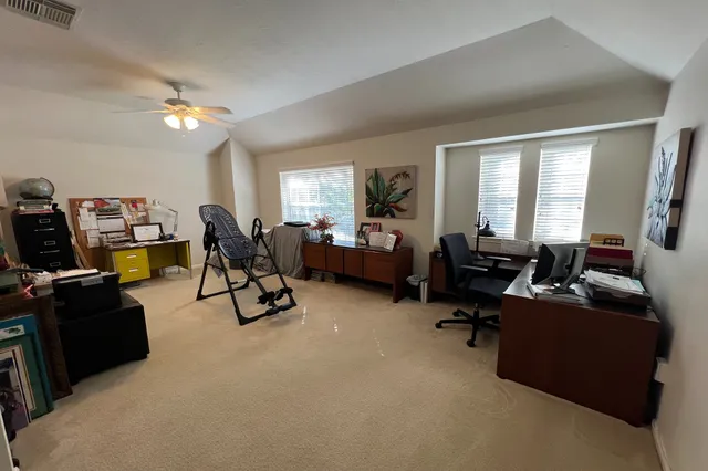 a view of a livingroom with workspace and a window
