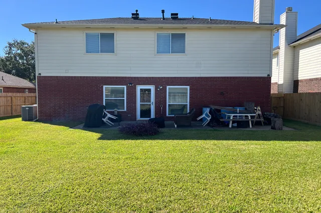a backyard of a house with table and chairs