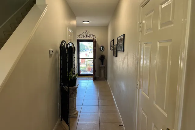 a view of a hallway with wooden floor