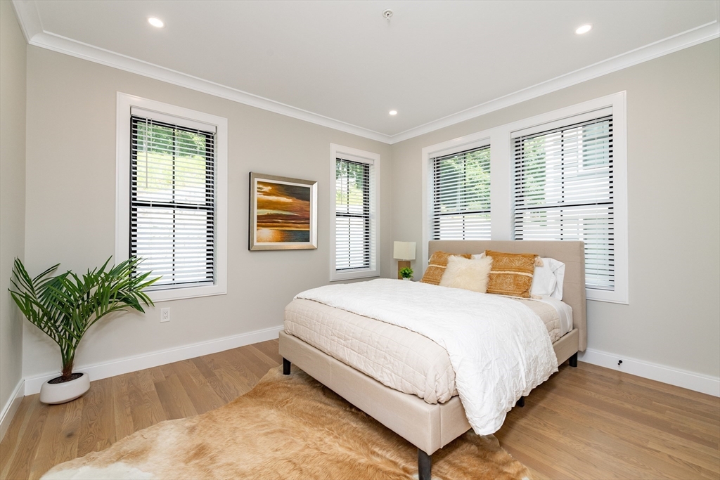 281 Lamartine Street Boston, MA 02130 - Photo 7 of 14 a bedroom with a large bed and a potted plant