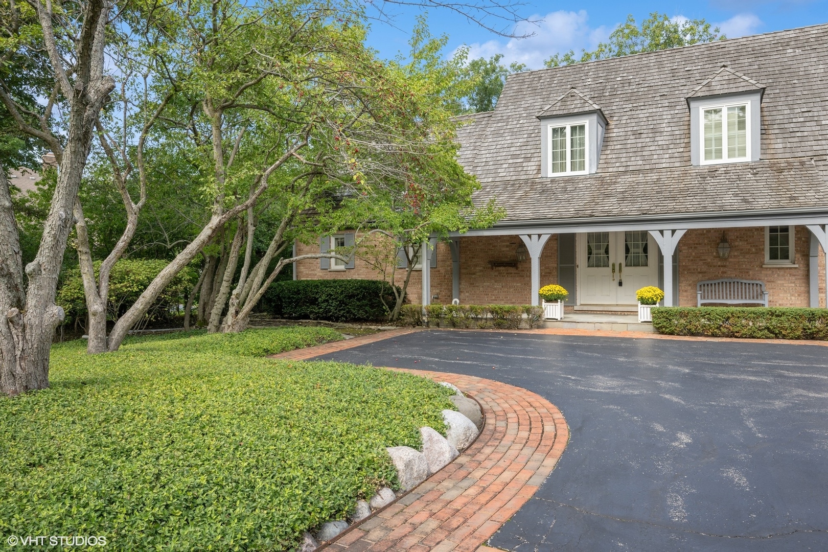 1100 Turicum Road Lake Forest, IL 60045 - Photo 2 of 38 a front view of a house with a yard and garage