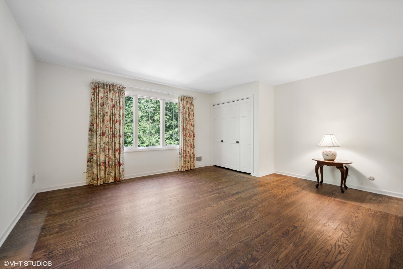 1100 Turicum Road Lake Forest, IL 60045 - Photo 25 of 38 a view of an empty room with wooden floor and a window