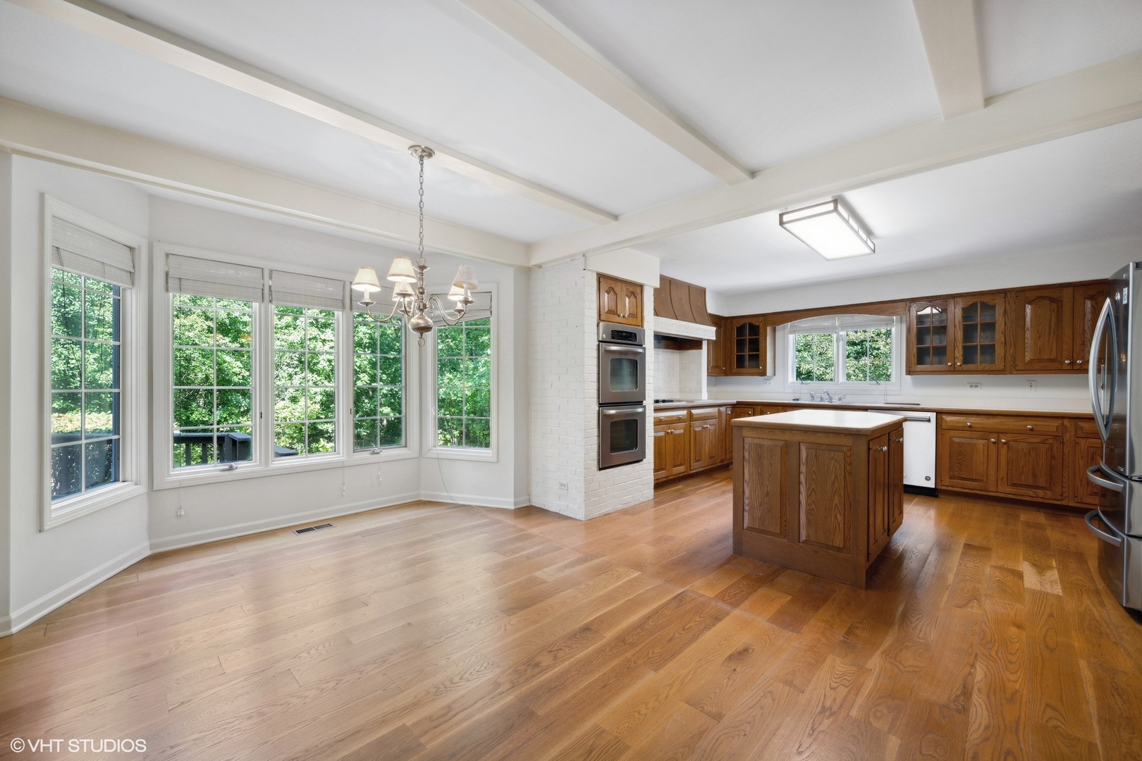 1100 Turicum Road Lake Forest, IL 60045 - Photo 8 of 38 a kitchen with stainless steel appliances wooden floors and wooden cabinets