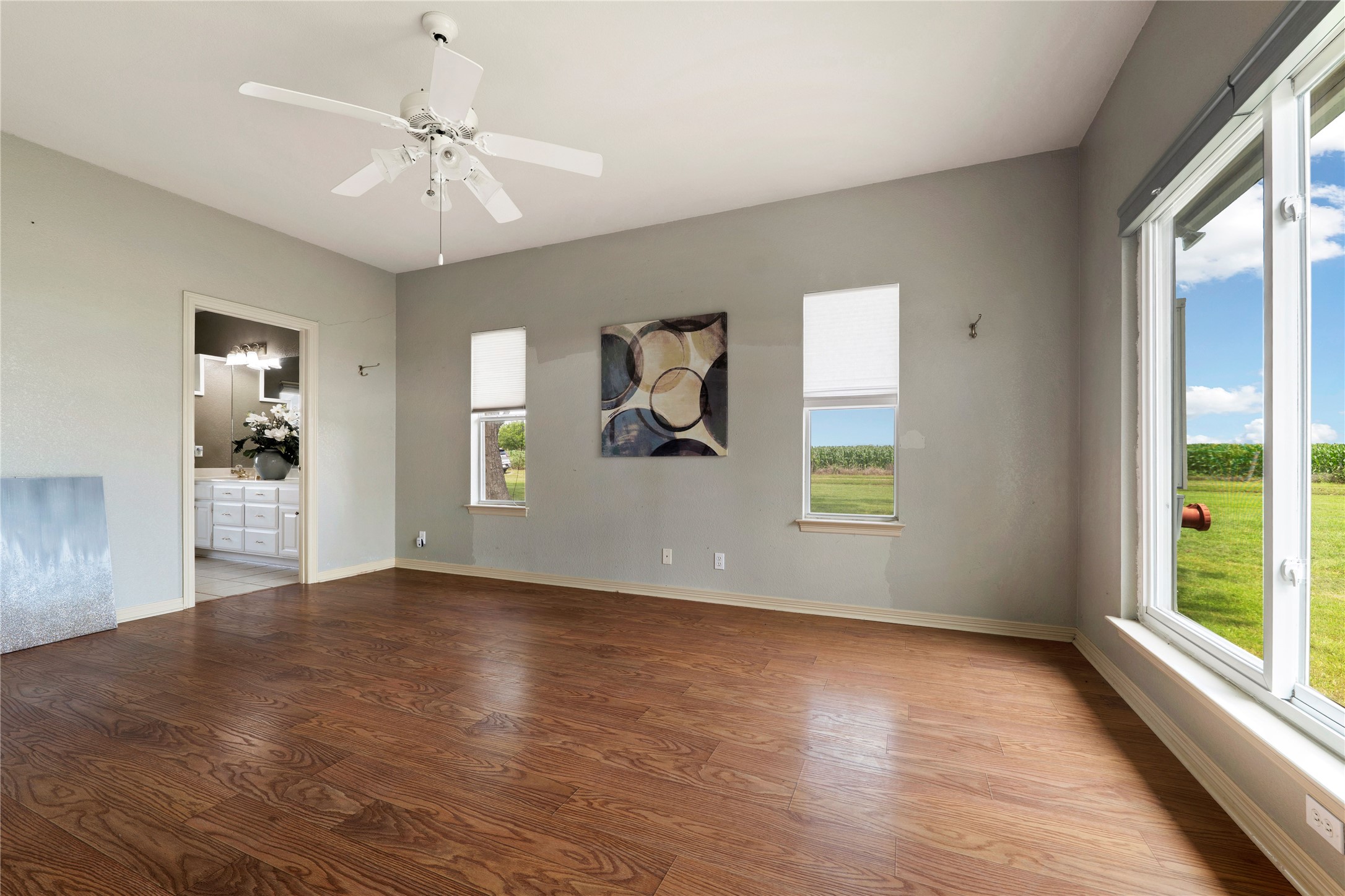 1005 East Buttercup Road Taylor, TX 76574 - Photo 15 of 38 an empty room with wooden floor and windows