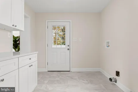 a view of a bathroom with sink mirror and window