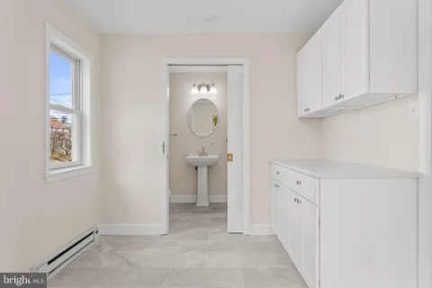 a bathroom with a sink a mirror and a shower