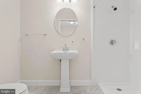 a bedroom with a bed wooden floor and window