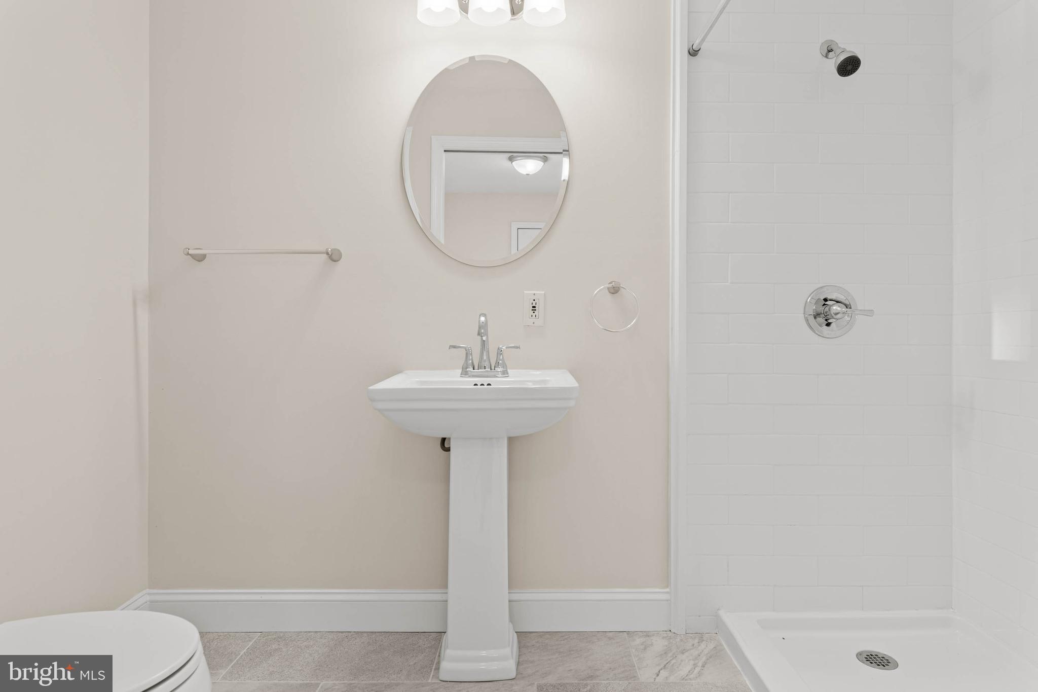 115 President Avenue Rutledge, PA 19070 - Photo 15 of 34 a bathroom with a sink a mirror and a shower