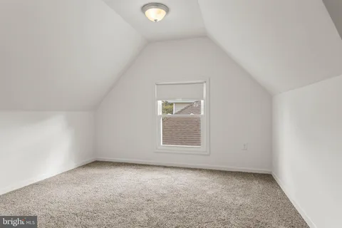 a view of a white house with a yard