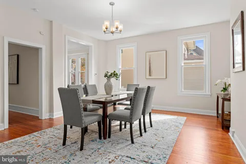 a view of a dining room with furniture wooden floor and a chandelier