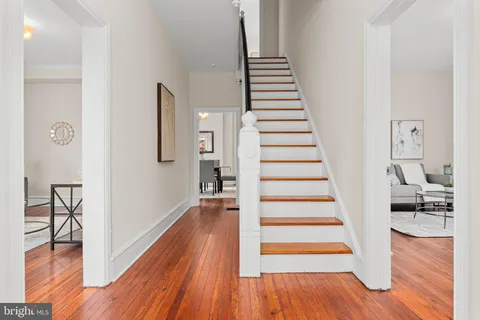 a view of a room with wooden floor and stairs