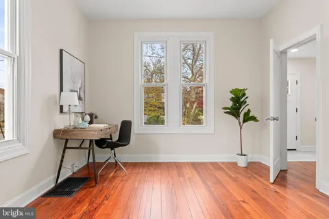 a view of a livingroom with furniture and a potted plant