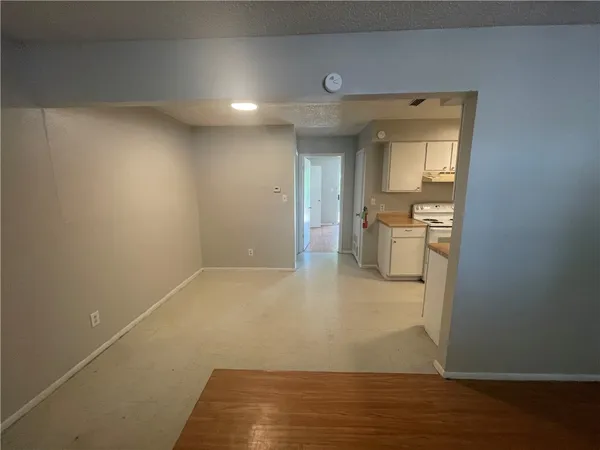 a view of a room with wooden floor and a sink