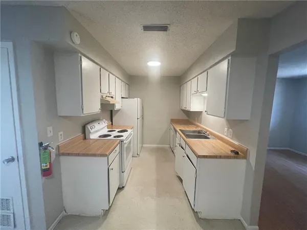a kitchen with stainless steel appliances granite countertop a stove and a refrigerator