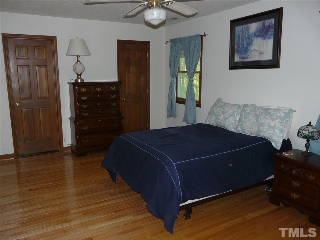 6815 Guess Road Rougemont, NC 27572 - Photo 14 of 20 a bedroom with a bed and a dresser