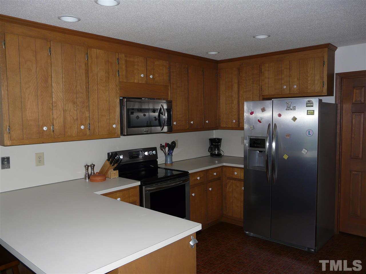 6815 Guess Road Rougemont, NC 27572 - Photo 8 of 20 a kitchen with granite countertop a refrigerator stove and sink