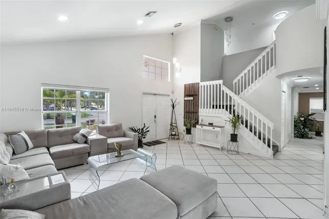 a living room with furniture and stairs