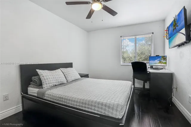 a bedroom with a bed a table and chair