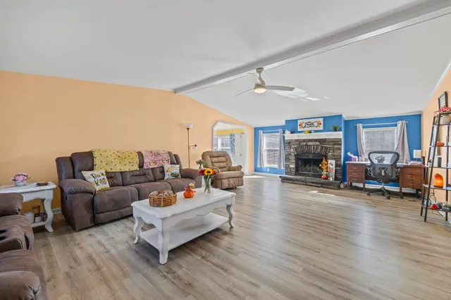 a living room with furniture and a fireplace