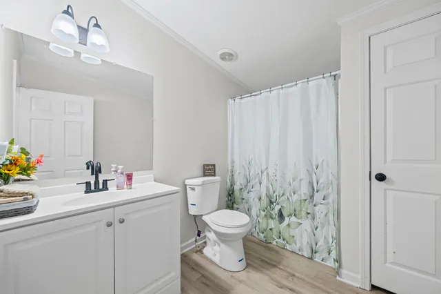 a bathroom with a toilet a sink and a mirror