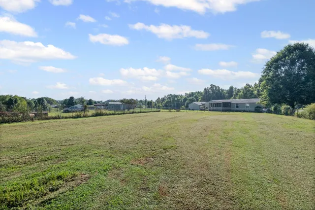 a view of a house with a backyard