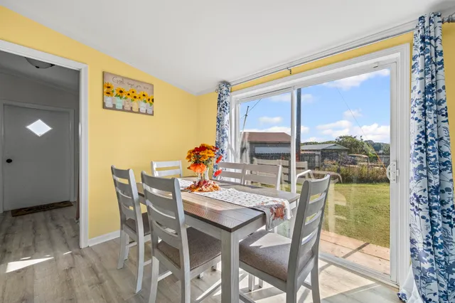 a dining room with furniture and a window