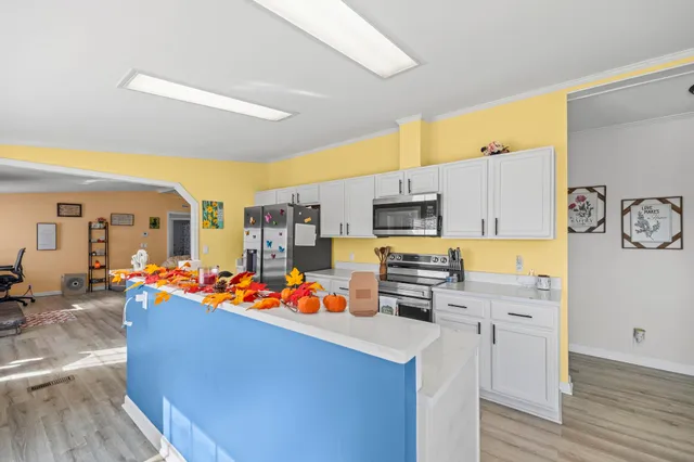a view of a kitchen with dining area a sink and a refrigerator