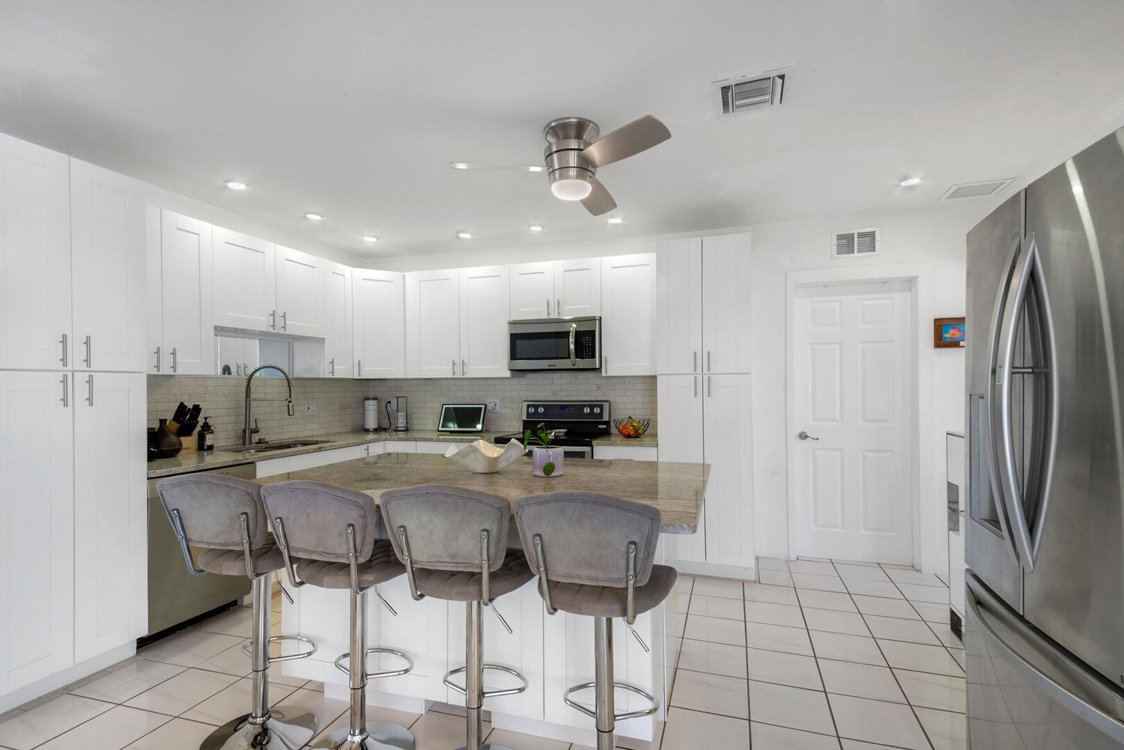 220 Southeast 2nd Avenue Pompano Beach, FL 33060 - Photo 11 of 43 a kitchen with stainless steel appliances granite countertop a refrigerator and a stove top oven