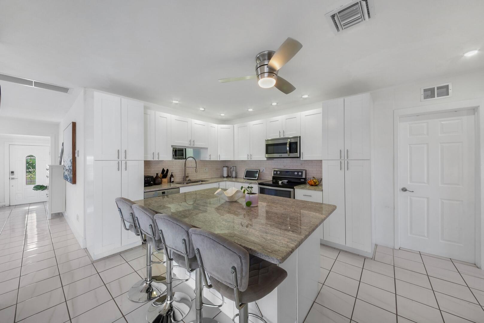 220 Southeast 2nd Avenue Pompano Beach, FL 33060 - Photo 12 of 43 a view of kitchen and dining area with chandelier
