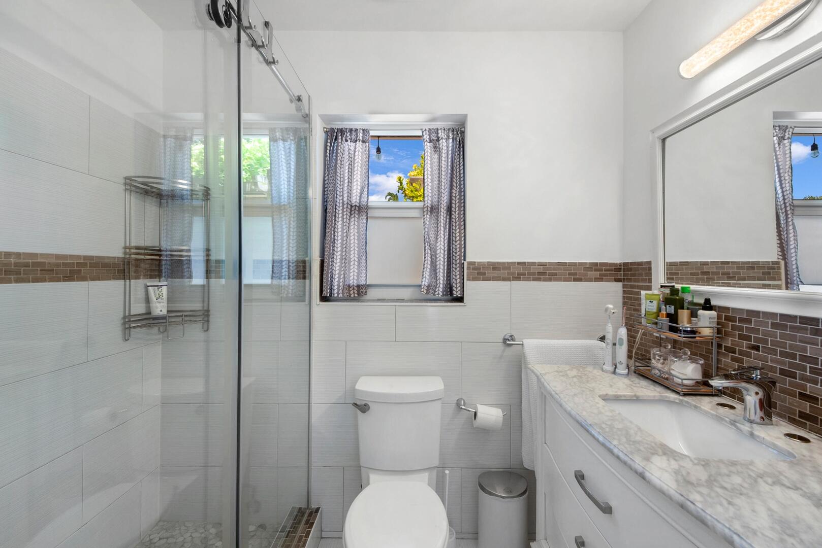 220 Southeast 2nd Avenue Pompano Beach, FL 33060 - Photo 15 of 43 a bathroom with a granite countertop toilet sink and mirror