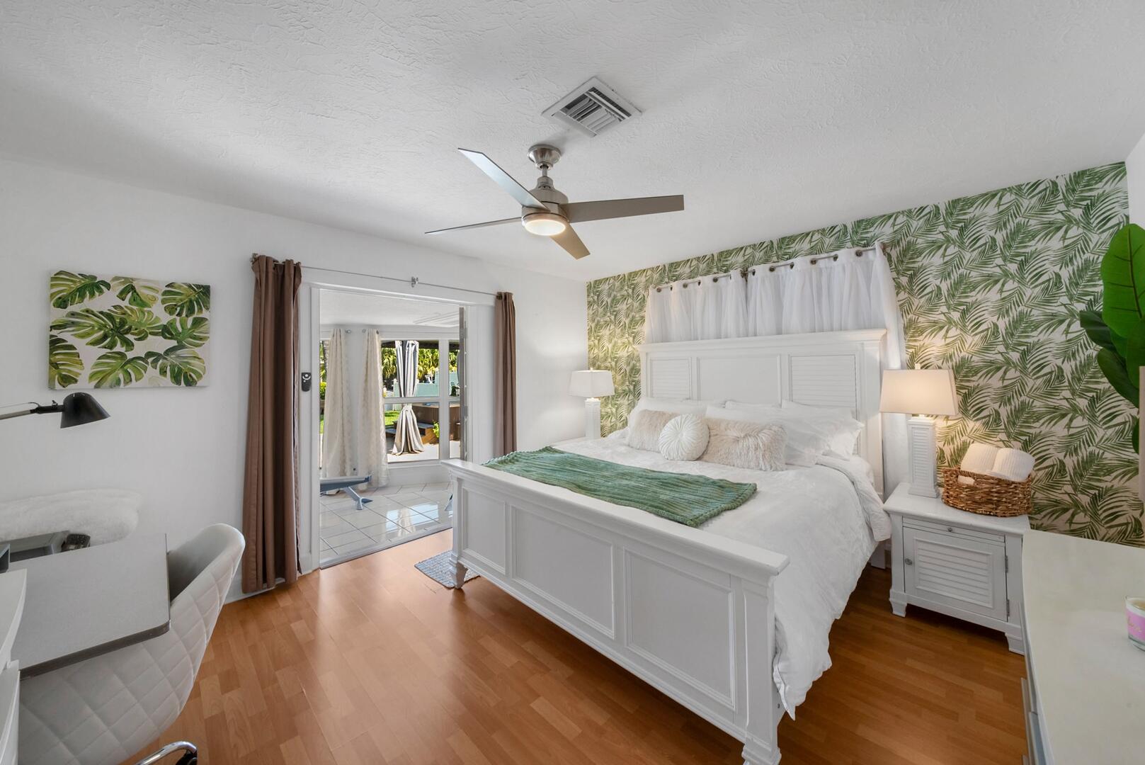 220 Southeast 2nd Avenue Pompano Beach, FL 33060 - Photo 16 of 43 a white bed sitting in a bedroom next to a window with a chandelier