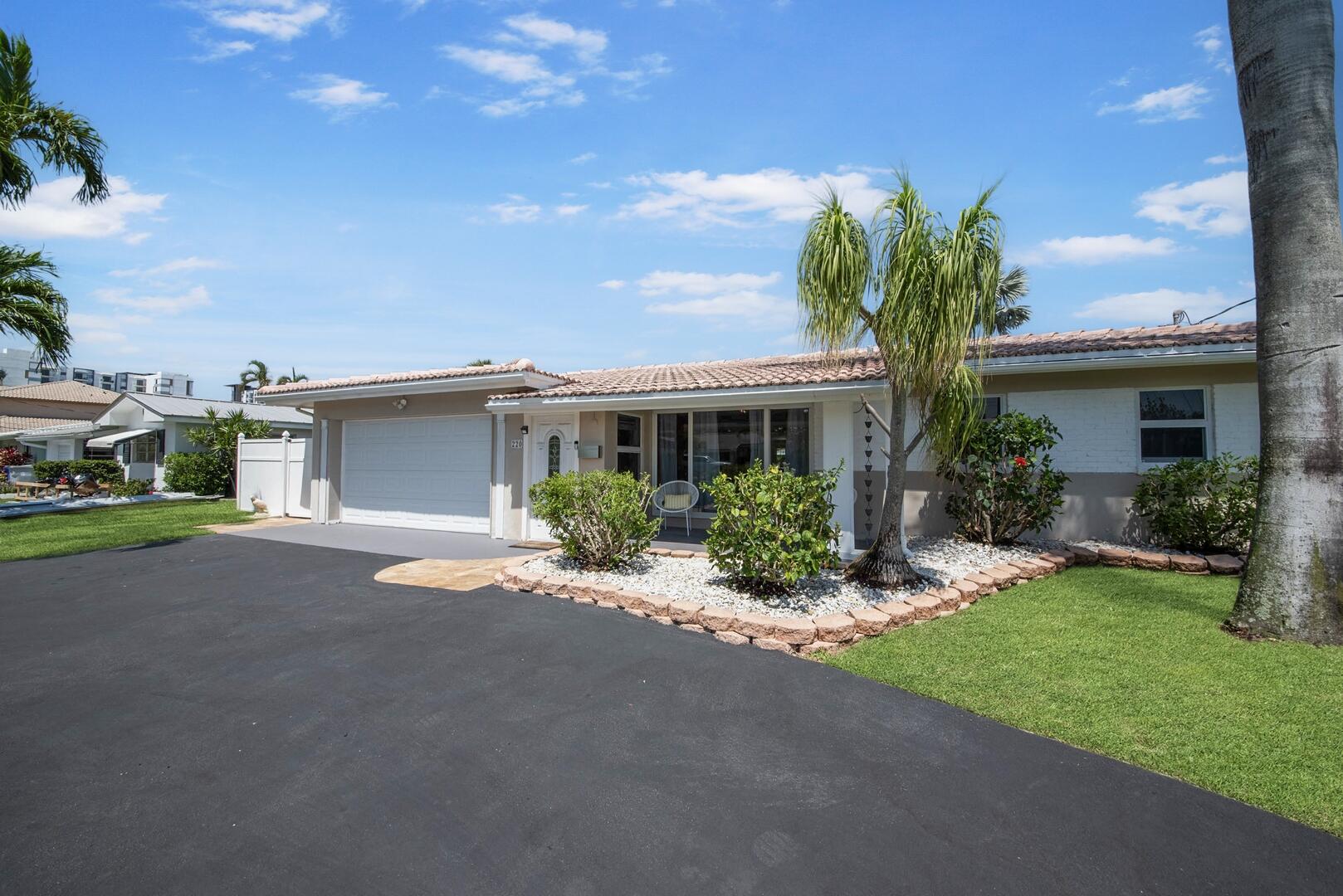 220 Southeast 2nd Avenue Pompano Beach, FL 33060 - Photo 38 of 43 a front view of a house with a yard and garage